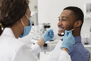 young man attending dental cleaning with dentist in Rockville 