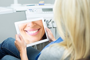 Woman looking at smile on tablet computer