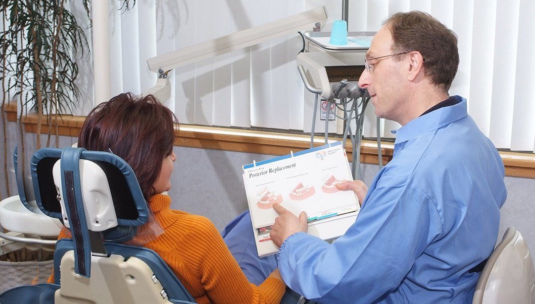 Dr. Sanker talking to patient in dental chair