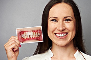 Woman with beautiful smile holding up before picture