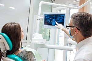 dentist showing a patient their X-rays