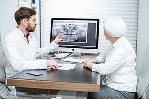 dentist showing a patient their dental X-rays