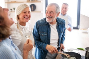 older man cooking and smiling   