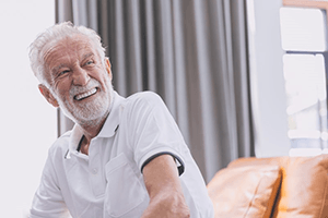 a man smiling with his new dentures in Rockville