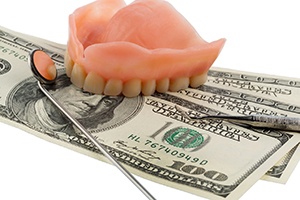 Dentures for upper arch on hundred dollar pills with mirror