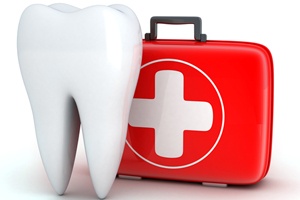 Model of a tooth next to a first-aid kit