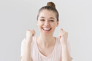 woman smiling after getting tooth extractions in Rockville