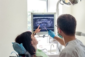 a dentist showing a patient their X-rays