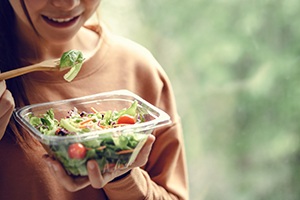 Close-up of a woman eating a salad