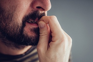 Close-up of a man biting his fingernails