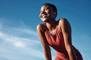 Smiling woman taking a break on run outside