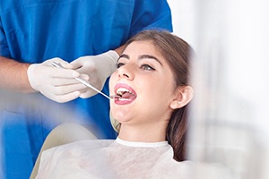 Woman receiving oral cancer screening