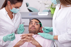 anxious person nervous about having their teeth cleaned by their dentist