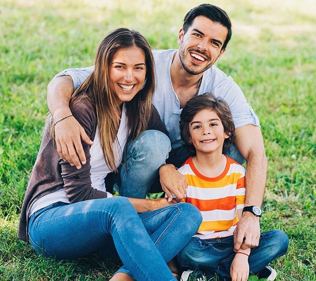 Smiling mother father and child outdoors