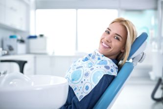 Smiling woman in dental chair 