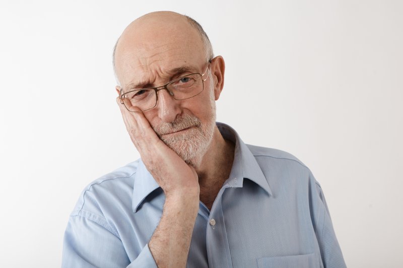 older man experiencing dental implant tooth sensitivity in rockville