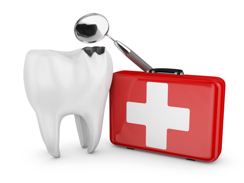 Decayed tooth and medical kit representing dental emergencies