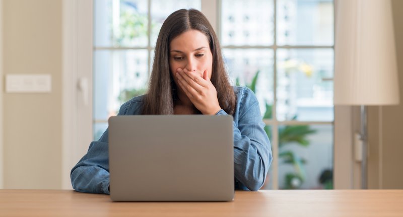 Upset woman covering her mouth