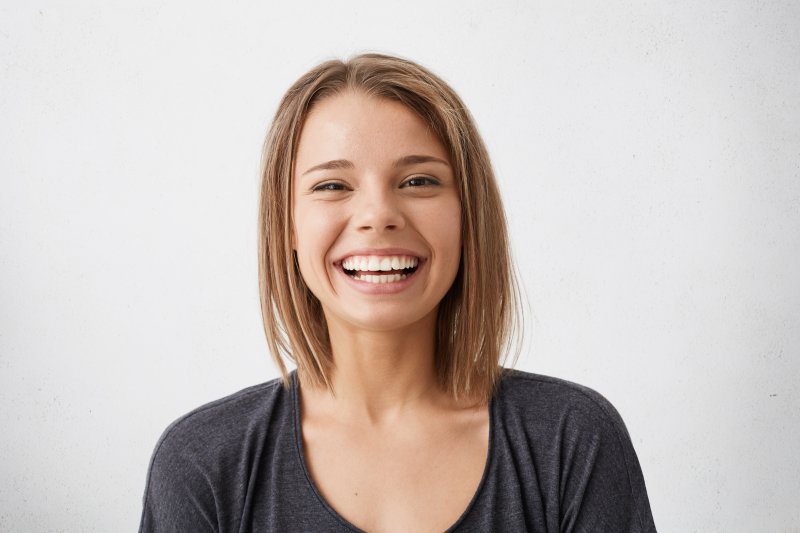 person who had dental implant surgery smiling