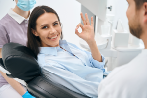 a patient smiling while visiting their dentist