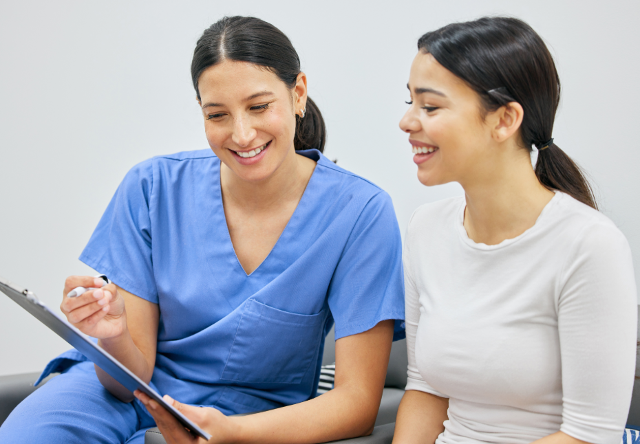 Dentist with patient, answering questions
